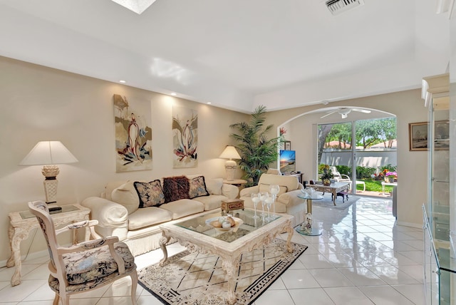living area with visible vents, light tile patterned floors, arched walkways, and recessed lighting