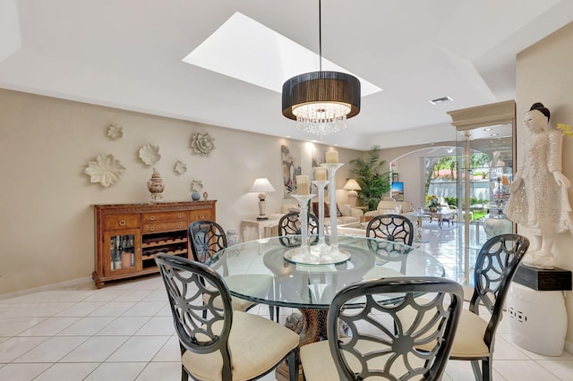 dining area with light tile patterned floors, visible vents, a notable chandelier, and baseboards