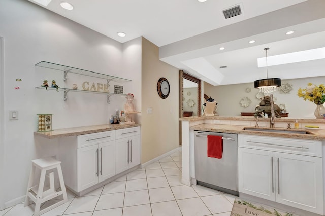 kitchen with stainless steel dishwasher, white cabinets, a sink, baseboards, and visible vents