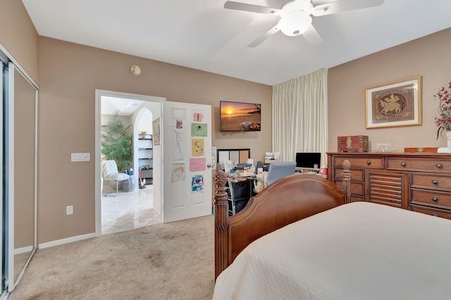 bedroom featuring ceiling fan, baseboards, and light carpet