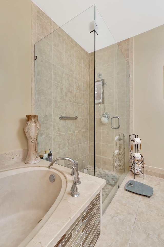 full bath with a bath, tile patterned flooring, and a shower stall