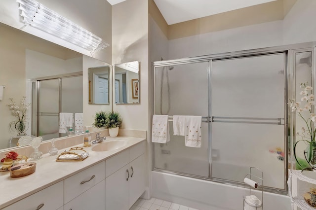 bathroom with bath / shower combo with glass door, tile patterned flooring, and vanity