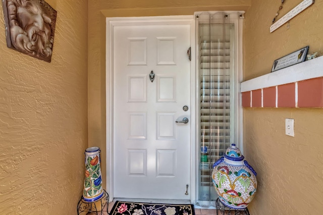 view of exterior entry with stucco siding