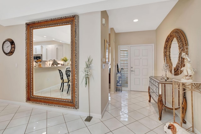hallway featuring light tile patterned floors, recessed lighting, and baseboards