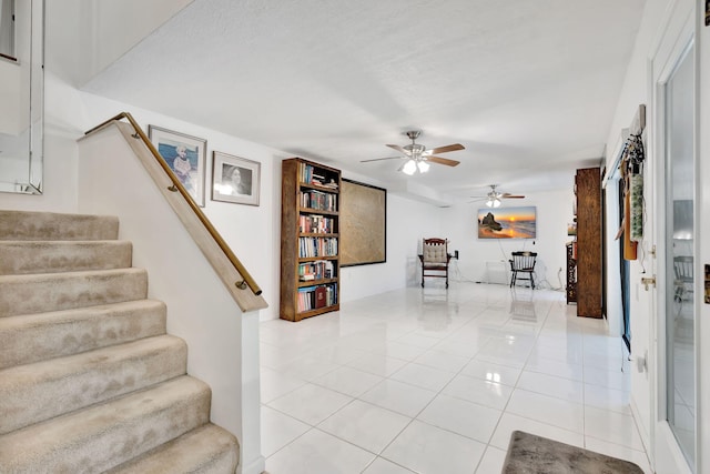 interior space with tile patterned floors and ceiling fan