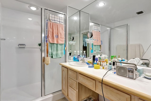 bathroom with visible vents, recessed lighting, a stall shower, and vanity