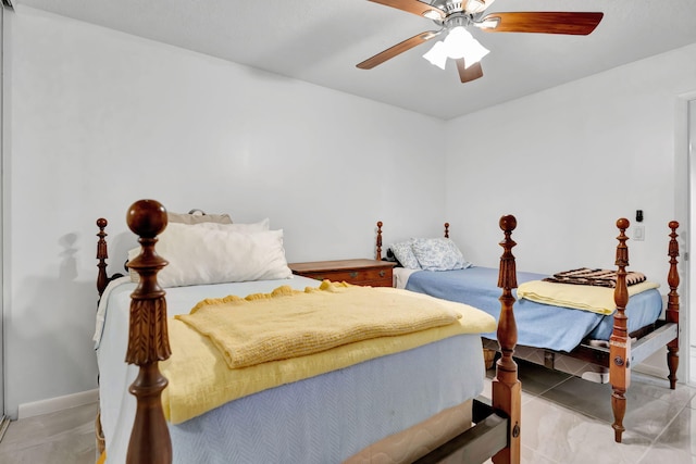 bedroom featuring baseboards and ceiling fan