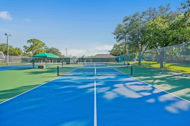 view of tennis court with fence