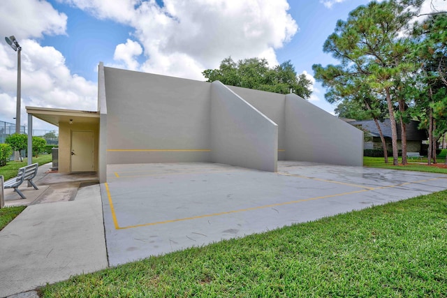 view of home's exterior with a lawn and stucco siding
