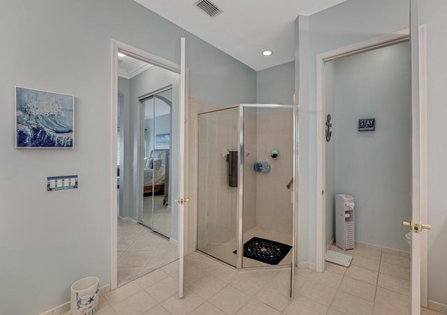 ensuite bathroom featuring toilet, tile patterned flooring, visible vents, and a stall shower