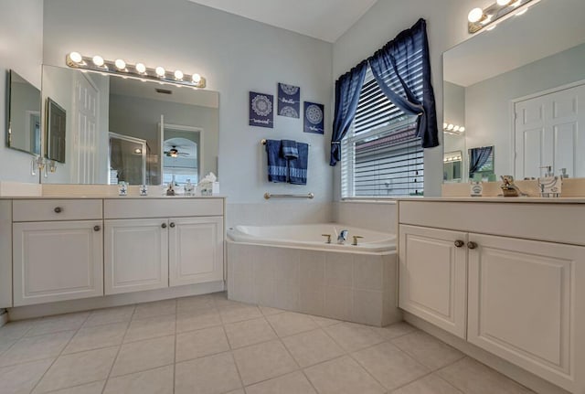 bathroom with tile patterned flooring, a ceiling fan, two vanities, a garden tub, and a stall shower