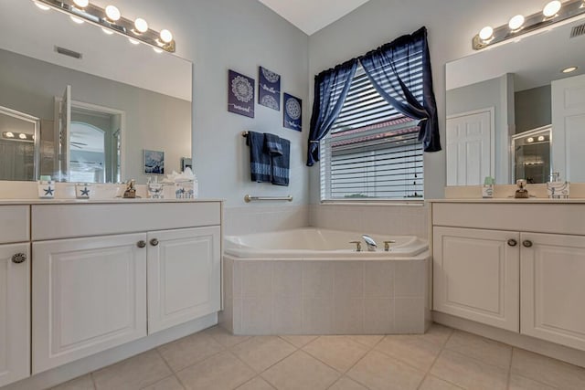 bathroom featuring two vanities, a stall shower, visible vents, tile patterned flooring, and a garden tub