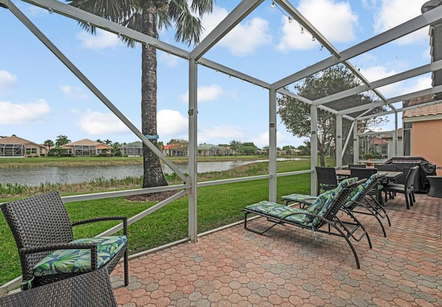 sunroom / solarium featuring a water view