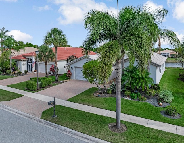 view of front of house featuring stucco siding, a front lawn, decorative driveway, and a garage