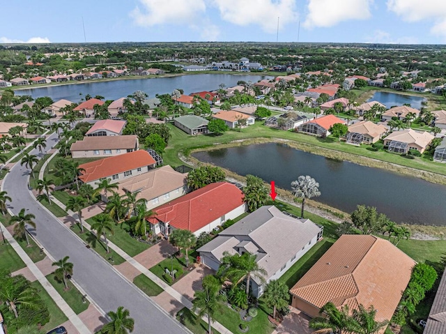 birds eye view of property featuring a water view and a residential view