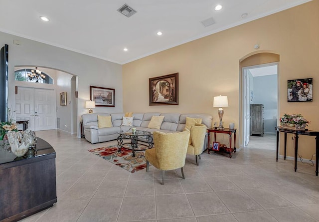 living room featuring visible vents, light tile patterned floors, arched walkways, crown molding, and a notable chandelier