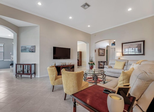 living area featuring arched walkways, recessed lighting, and light tile patterned floors