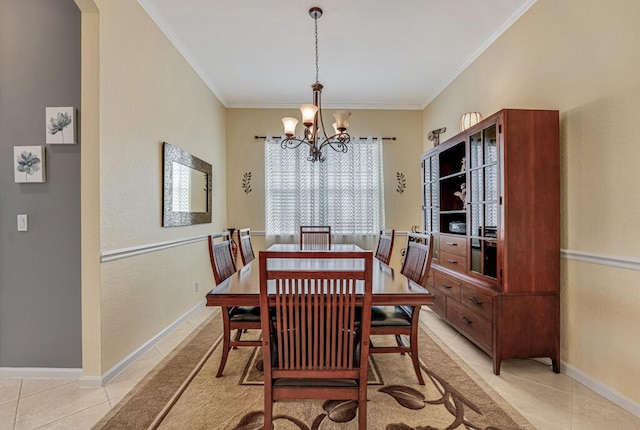 dining space featuring an inviting chandelier, baseboards, ornamental molding, and light tile patterned floors