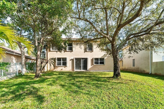 865 Gazetta Way, West Palm Beach, FL 33413 - rear view of property with a yard, stucco siding, and fence