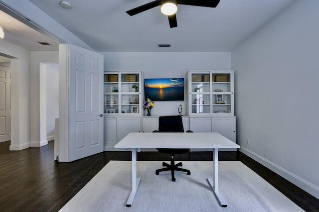 office space with baseboards, a ceiling fan, dark wood finished floors, and visible vents