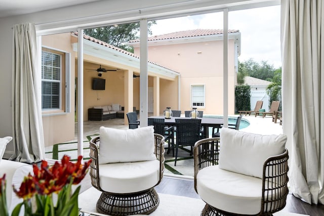 view of patio with outdoor dining area, a ceiling fan, an outdoor pool, and an outdoor living space