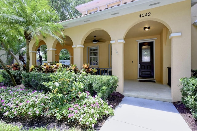 property entrance with stucco siding and a porch