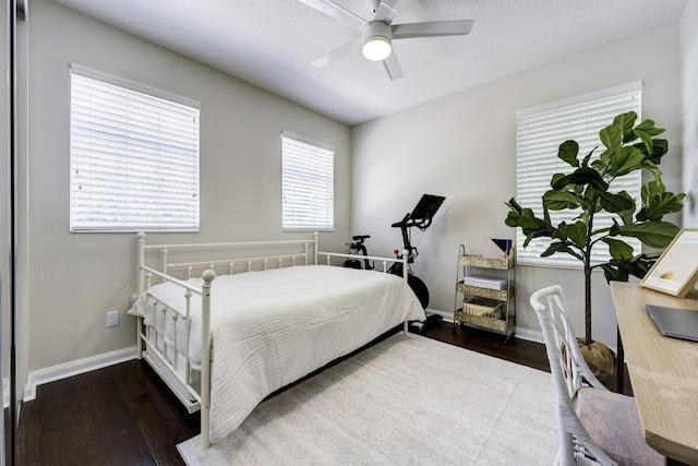 bedroom with baseboards, ceiling fan, and wood finished floors