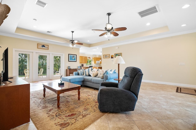 4732 SE Starling Cir, Stuart, FL 34997 - living room featuring visible vents, light tile patterned floors, a ceiling fan, and a tray ceiling