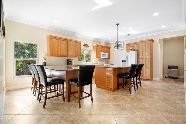 4732 SE Starling Cir, Stuart, FL 34997 - kitchen featuring a kitchen breakfast bar, crown molding, a kitchen island, recessed lighting, and white appliances