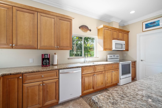 4732 SE Starling Cir, Stuart, FL 34997 - kitchen with light stone countertops, white appliances, brown cabinets, a sink, and crown molding