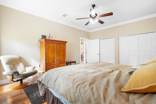 4732 SE Starling Cir, Stuart, FL 34997 - bedroom with crown molding, light wood-style floors, visible vents, baseboards, and two closets