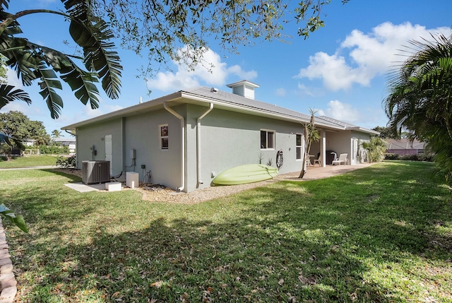 4732 SE Starling Cir, Stuart, FL 34997 - back of property with a patio, stucco siding, a yard, and central air condition unit