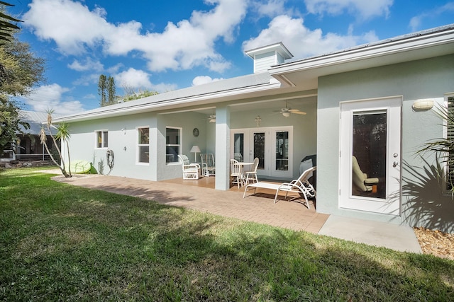 4732 SE Starling Cir, Stuart, FL 34997 - rear view of property featuring a patio area, a yard, a ceiling fan, stucco siding, and french doors