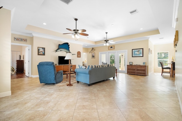 4732 SE Starling Cir, Stuart, FL 34997 - living room featuring visible vents, light tile patterned floors, a raised ceiling, and ornamental molding