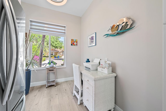 office space with baseboards and light wood-type flooring