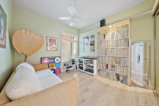 living area featuring ceiling fan and wood finished floors