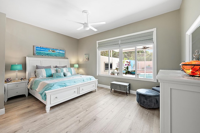 bedroom featuring baseboards, light wood finished floors, and ceiling fan