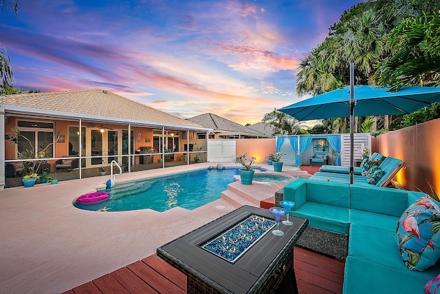 view of pool featuring a fenced backyard, a fenced in pool, a ceiling fan, a patio, and a fire pit