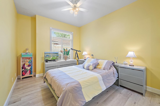 bedroom featuring baseboards, a ceiling fan, and wood finished floors