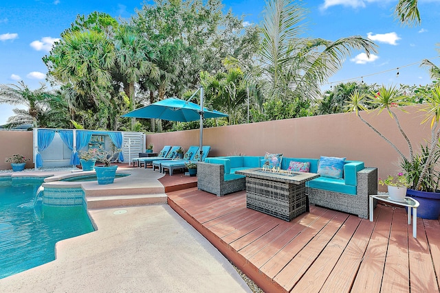 wooden terrace featuring an outdoor hangout area, a fenced backyard, and a pool with connected hot tub