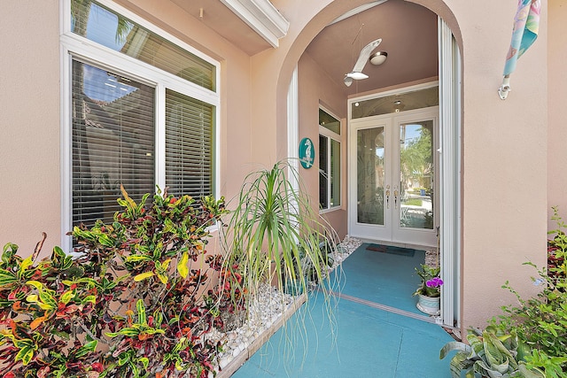 doorway to property featuring stucco siding and french doors