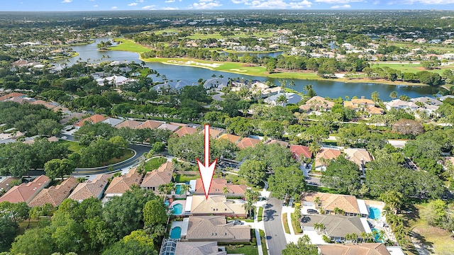 drone / aerial view featuring a water view and a residential view
