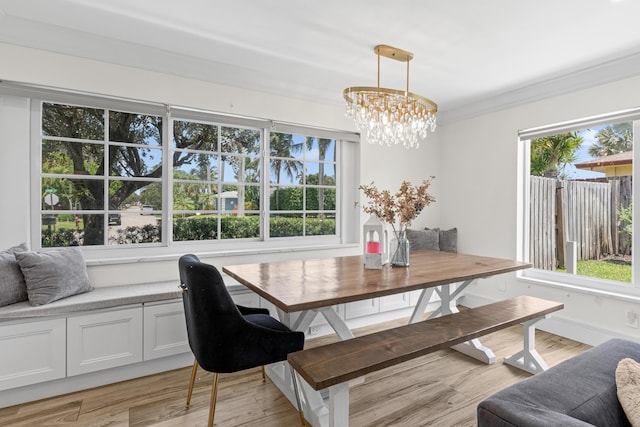912 Roberts Rd, Delray Beach, FL 33483 - dining area featuring an inviting chandelier, a healthy amount of sunlight, and light wood-style floors