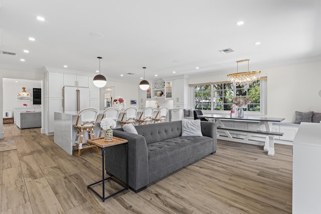 912 Roberts Rd, Delray Beach, FL 33483 - living room with ornamental molding, recessed lighting, visible vents, and light wood-style flooring