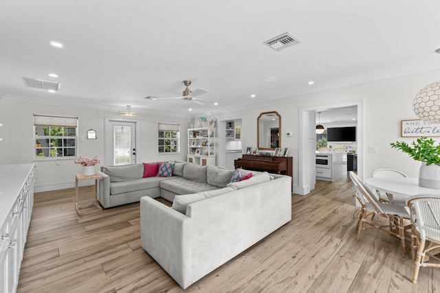 912 Roberts Rd, Delray Beach, FL 33483 - living room with ornamental molding, visible vents, and light wood-style floors