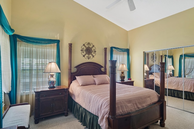 bedroom featuring ceiling fan, vaulted ceiling, and light carpet