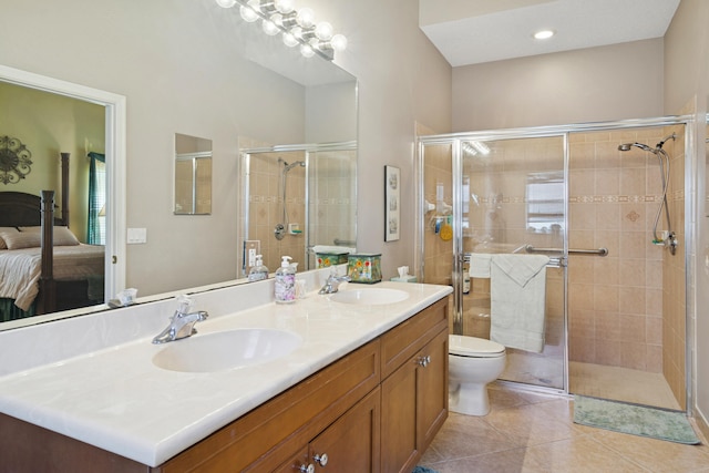 ensuite bathroom featuring a stall shower, tile patterned flooring, double vanity, and a sink