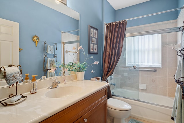 full bath featuring toilet, bath / shower combo with glass door, and vanity