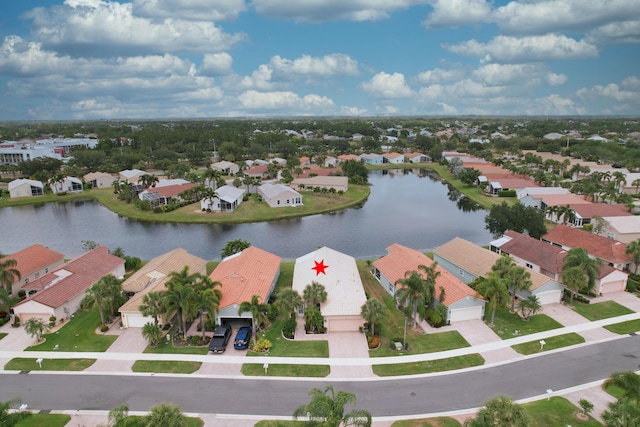 drone / aerial view with a residential view and a water view