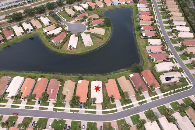birds eye view of property with a water view and a residential view